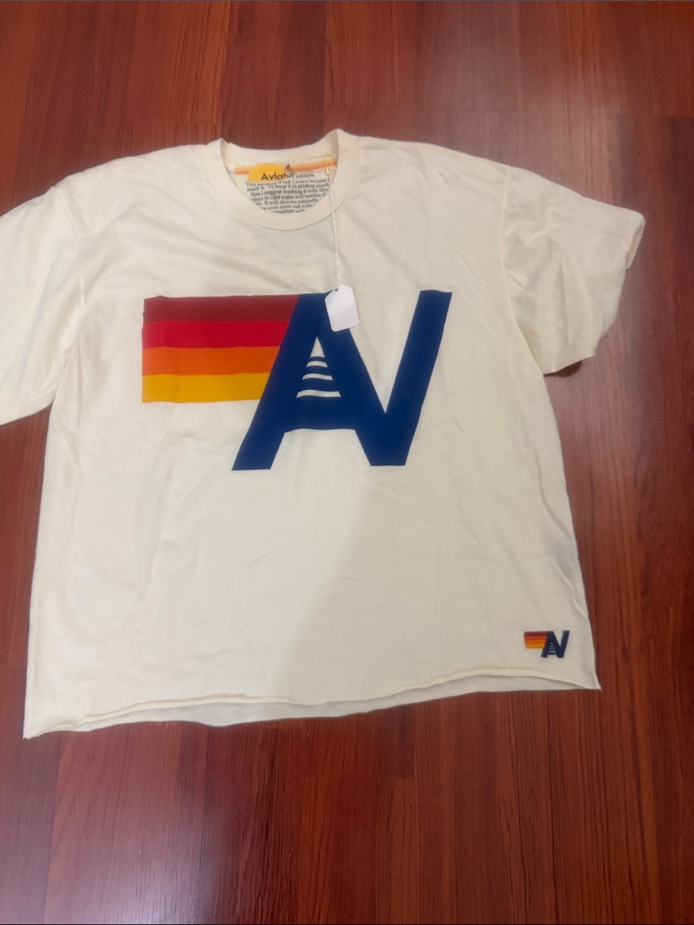 Aviator Nation Cream Tee with Navy AV Logo and Red-Orange-Yellow Stripe